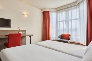 Postel nebo postele na pokoji v ubytování Theater Hotel