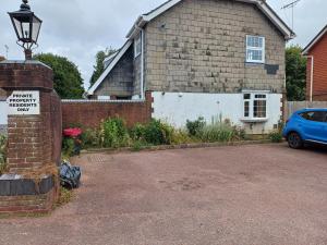 a house with a sign in front of a driveway at Arundel Central Apartment with parking in Arundel