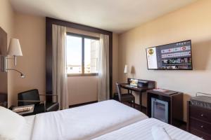 Postel nebo postele na pokoji v ubytování B&B Hotel Arezzo