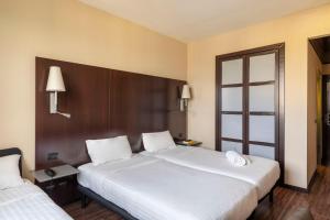 Postel nebo postele na pokoji v ubytování B&B Hotel Arezzo