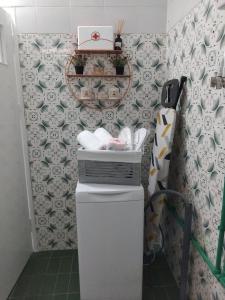 a bathroom with a toilet and a wallpaper at TO ARCHONTIKO La maison de ville in Ávaton +50 photos