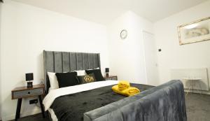 a yellow stuffed animal sitting on top of a bed at An Elegant 3 Bedroom House in Aberdeen +16 photos