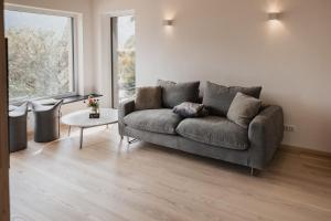 a living room with a couch and a table at Gutzeit-Appartements mit privater Infrarotkabine in Bad Hindelang
