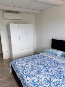 una camera da letto con un letto e un armadio bianco di Corallo by Residence Rena Bianca a Baja Sardinia