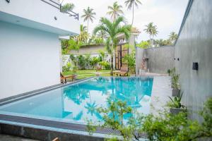 a swimming pool in the backyard of a house at Hirigala Beach Resort in Ahangama