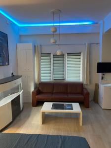 a living room with a couch and a coffee table at So Good Studio in Onești