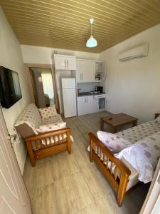 a small room with two beds and a kitchen at Göksel Apart in Mersin