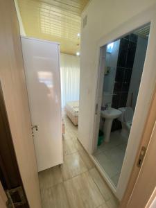 a bathroom with a toilet and a sink and a mirror at Göksel Apart in Mersin