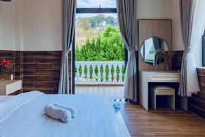 a bedroom with a bed with a mirror and a fireplace at White Villa Đà Lạt in Da Lat