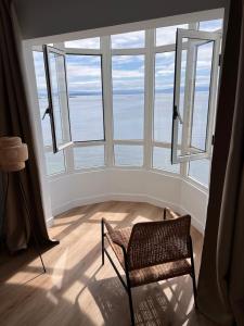 a room with a chair in front of a large window at Ribeira Flats in Ribeira