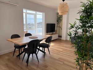 a dining room with a wooden table and chairs at Ribeira Flats in Ribeira