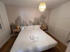 a bedroom with a large white bed with two tables at Ribeira Flats in Ribeira