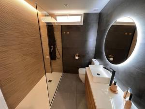 a bathroom with a sink and a mirror at Ribeira Flats in Ribeira +16 photos