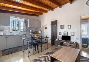 a kitchen and dining room with a table and chairs at Angela Apartment in Dhalamanára