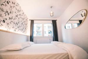 En eller flere senge i et værelse på Le Majestic - T2 en centre ville + 23 billeder