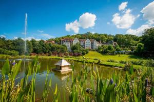 a garden with a pond with a gazebo in the middle at DoubleTree by Hilton Bristol South - Cadbury House in Yatton