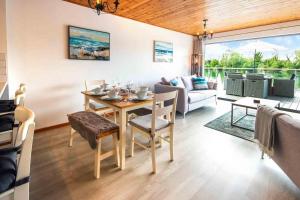 a living room with a dining table and a couch at Spring Lake 43, Jesse-Belle P in South Cerney