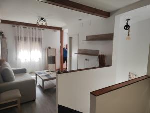 a person standing in a living room with a mirror at LA GARRUCHa in Argamasilla de Alba