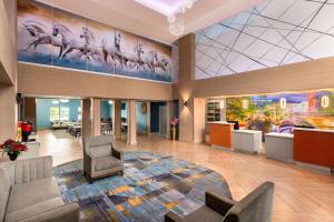 a large lobby with a large painting on the wall at La Quinta by Wyndham San Antonio North Stone Oak in San Antonio +28 photos