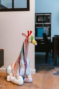 a colorful toy giraffe sitting on the floor in a living room at LE MIRAGE Luxury T4 avec garage in Annecy