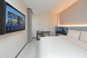 Ένα ή περισσότερα κρεβάτια σε δωμάτιο στο Atour Light Hotel Nanjing South Railway Station South Square