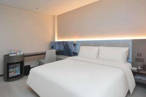 Ένα ή περισσότερα κρεβάτια σε δωμάτιο στο Atour Light Hotel Nanjing South Railway Station South Square