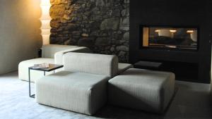 a living room with two chairs and a fireplace at Boutique Hotel Casa Giovanoli in Tomils