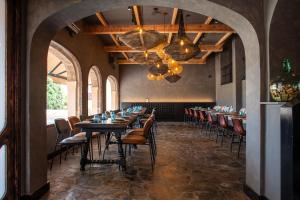 a dining room with a long table and chairs at Ona Lomas Village - La Manga Club in La Manga del Mar Menor