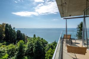 a view of the ocean from the balcony of a house at Green Cape Botanico in Batumi