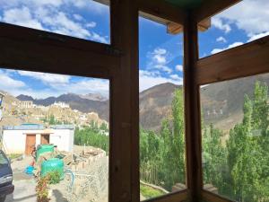 a view from a window of a mountain at Sangay Guest House Leh-Ladakh By LexStays in Leh