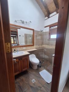 a bathroom with a toilet and a sink and a shower at Casa Campestre Flores Amarillas in Villa de Leyva +67 photos