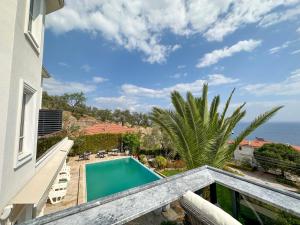 a view from the balcony of a house with a swimming pool at Suuyla Kazdagları in Edremit