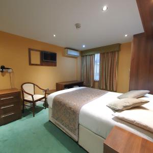 Postel nebo postele na pokoji v ubytování Oliver Hotel