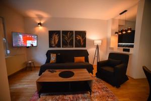 a living room with a couch and a coffee table at Apartman Palermo in Užice