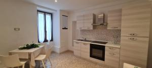 a kitchen with a table and a dining room at Rifugio dei Saraceni in Vallecrosia