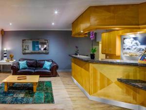 a living room with a couch and a table at Bishops Lodge in Gqeberha