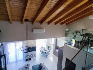 a living room with a table and a glass wall at Villa ArGia with private pool in Georgioupoli