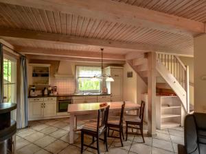 a kitchen with a table and chairs and a staircase at Das Haus am Meer in Baabe