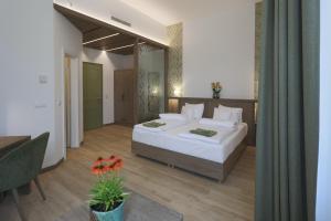 a bedroom with a large white bed and a table at Turul Villa in Sovata