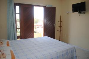 a bedroom with a bed and a sliding glass door at Residence Vila Europa in Porto Seguro +43 photos