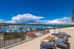 a balcony with chairs and a view of a marina at Villa Marin in Klimno