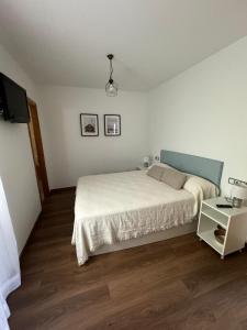a bedroom with a bed and a tv in it at Casa Emma in Burriana +19 photos