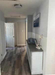 an empty room with a hallway with a door and a counter at North Hill Cottage in Pensacola