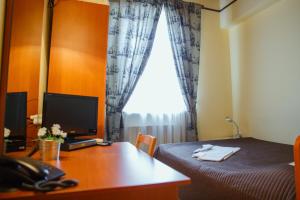 Un pat sau paturi într-o cameră la Mini Hotel Venezia