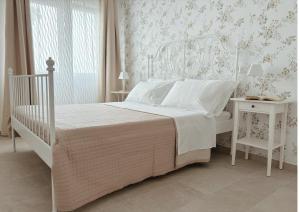 a bedroom with a white bed and a white table and chair at Feudi di Bisaccia in Montenero di Bisaccia +13 photos