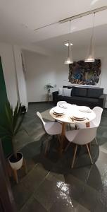 a living room with a white table and chairs at ALVEAR FLATS II in Posadas