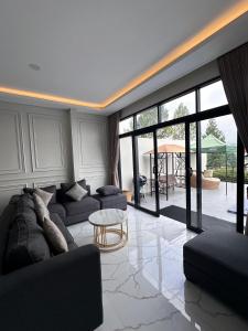 a living room with a couch and a table at VILLA NEOM PUNCAk in Sampal 2 +27 photos