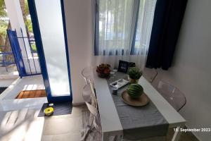a room with a table with a cactus on it at Poseidons Retreat optional el car and airporttrans in Sounio