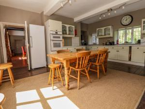a large kitchen with a wooden table and chairs at New Hall in Wrexham
