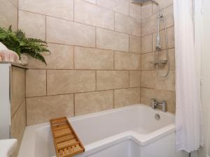 a bathroom with a white tub and a shower at West Pier Cottage in Macduff +23 photos